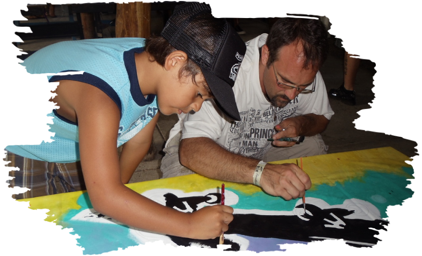 A man and boy painting on paper.